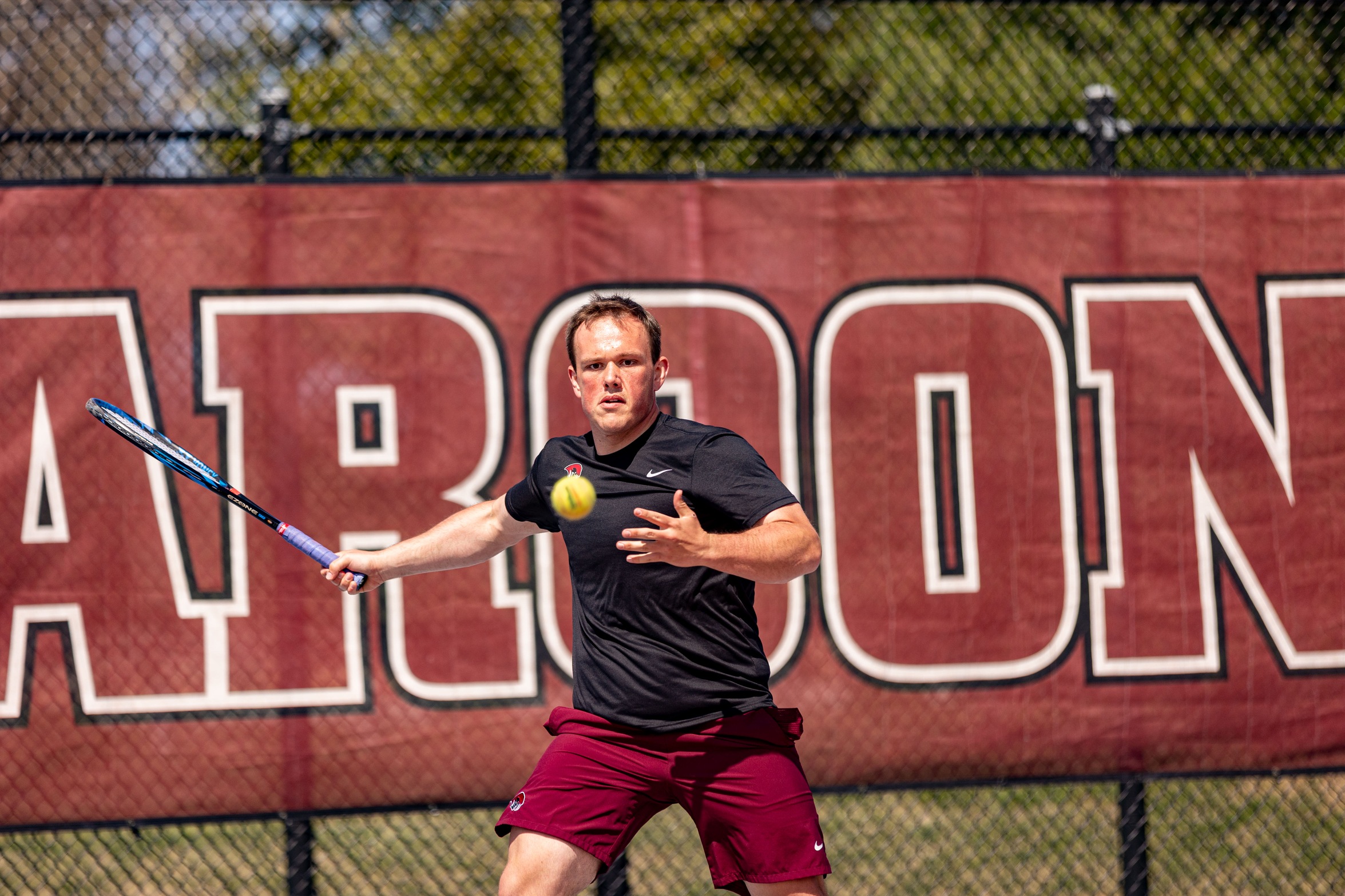 action photo of RC men's tennis player Jack Fishwick hitting a forehand