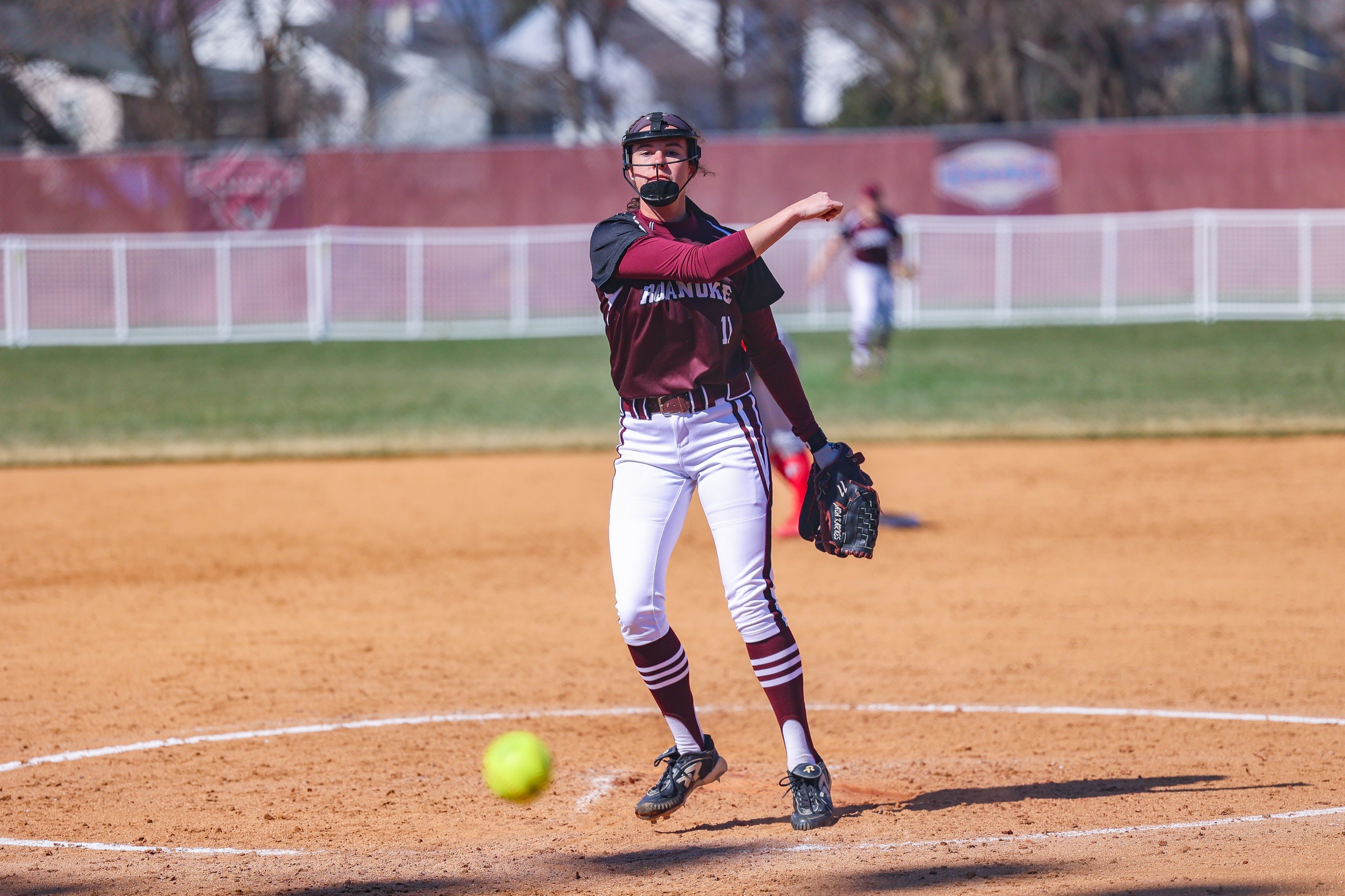 action photo of RC softball pitcher Jada Karnes delivering a pitch
