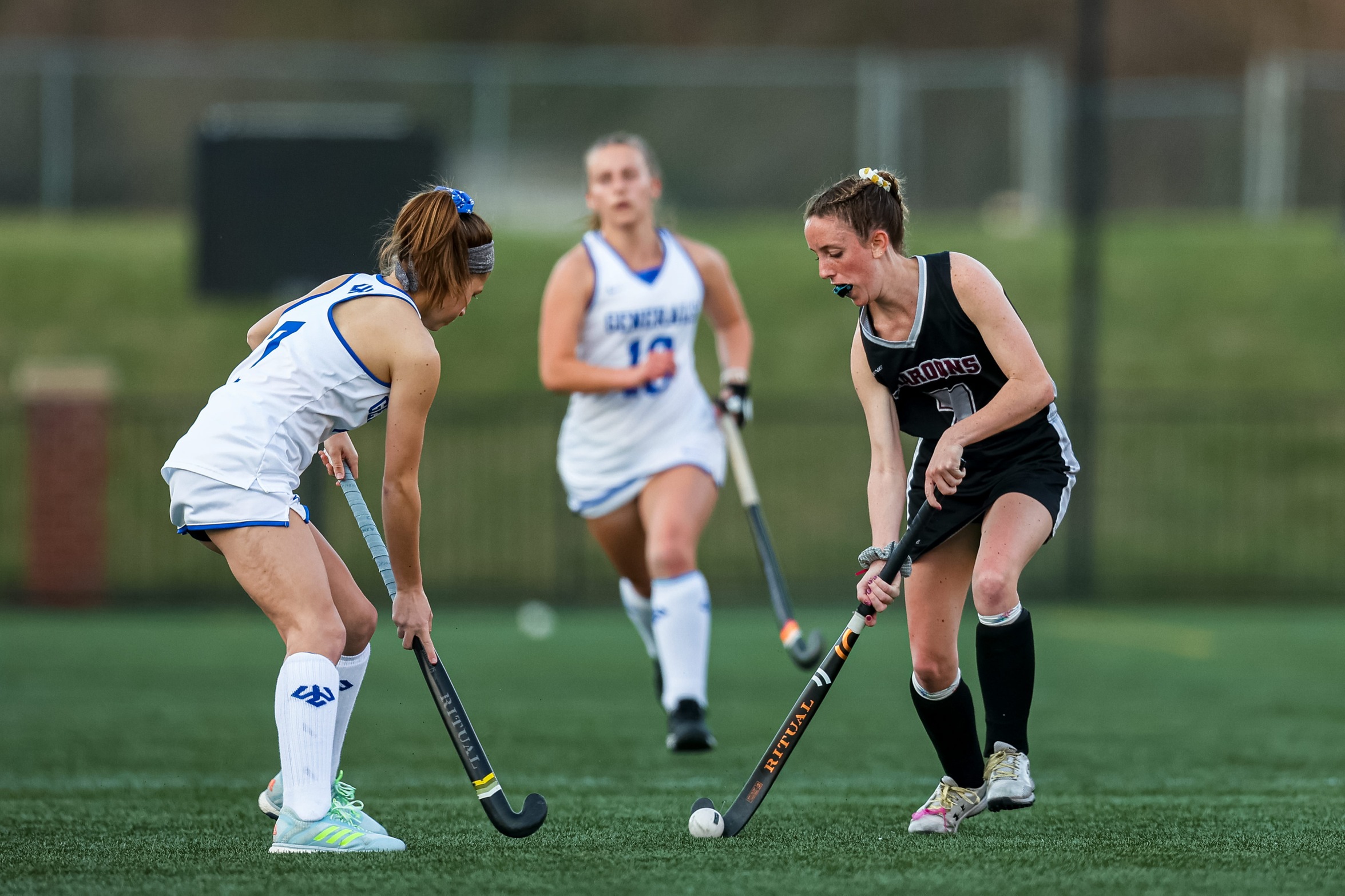 action photo of RC field hockey player Martha Hurley going against a defender