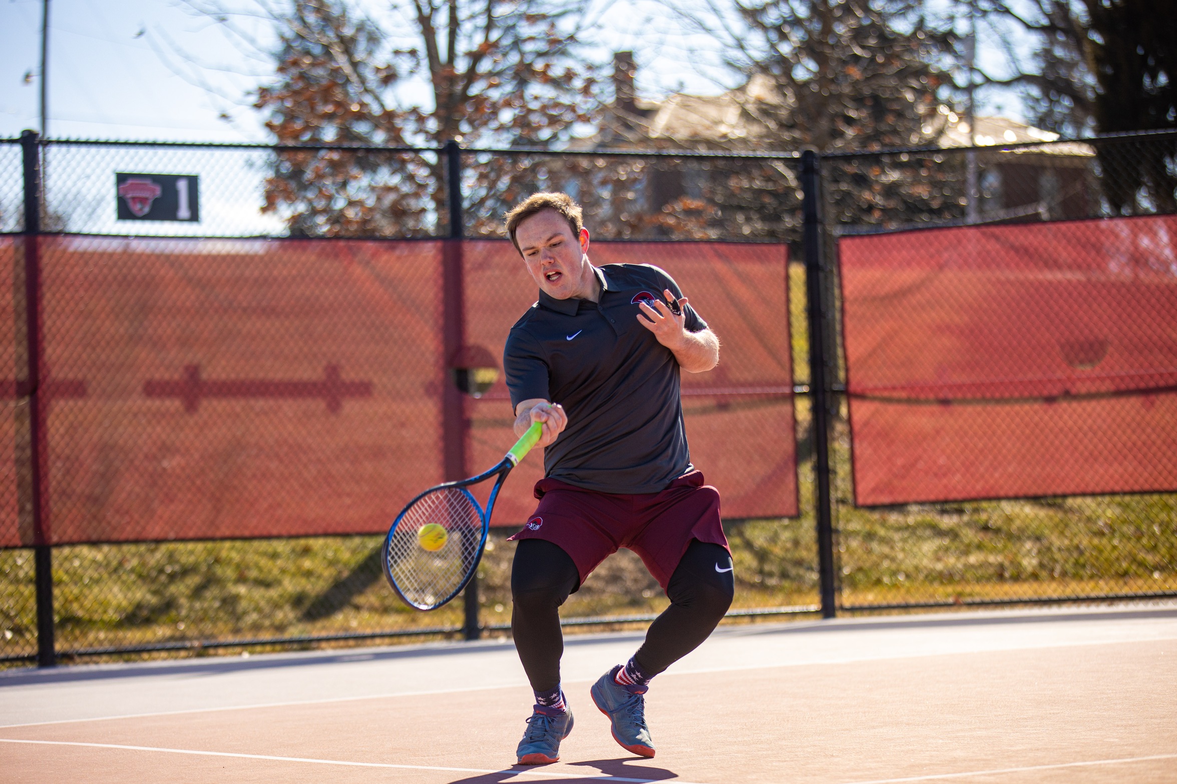 action photo of RC tennis player Jack Fishwick hitting a forehand