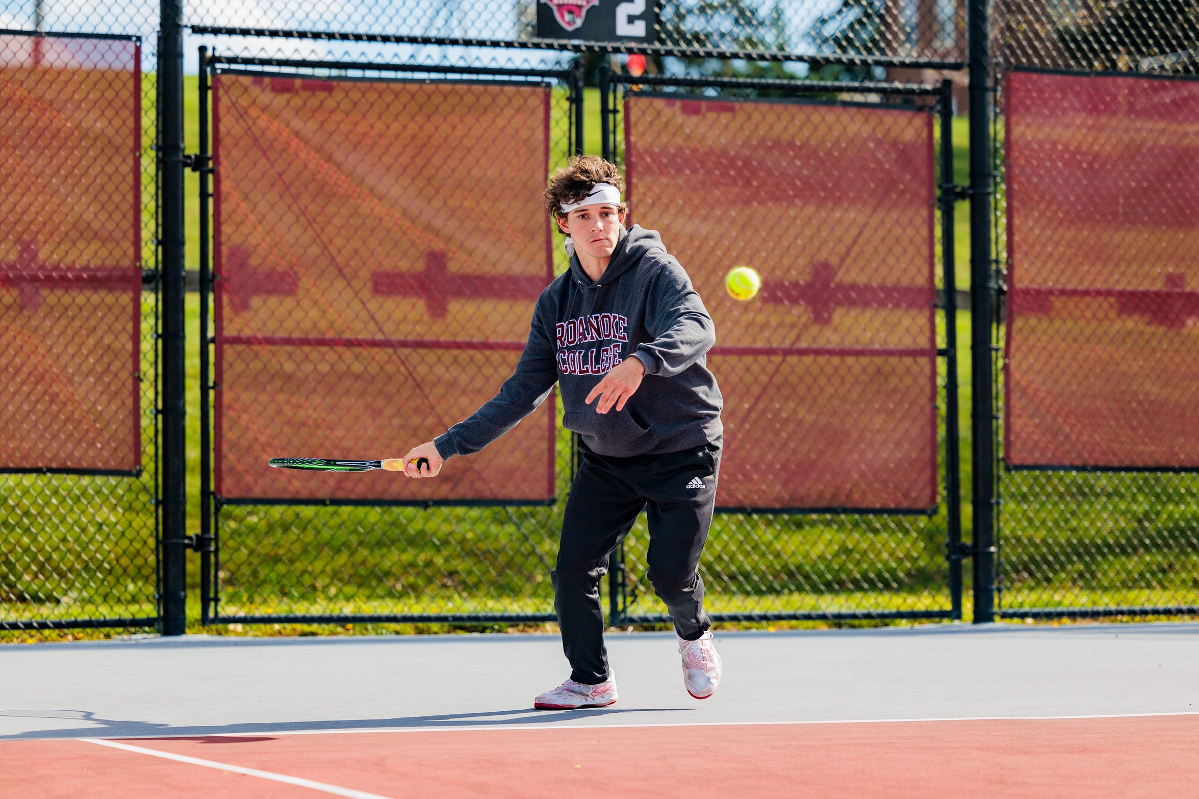 action photo of RC men's tennis player hitting a forehand