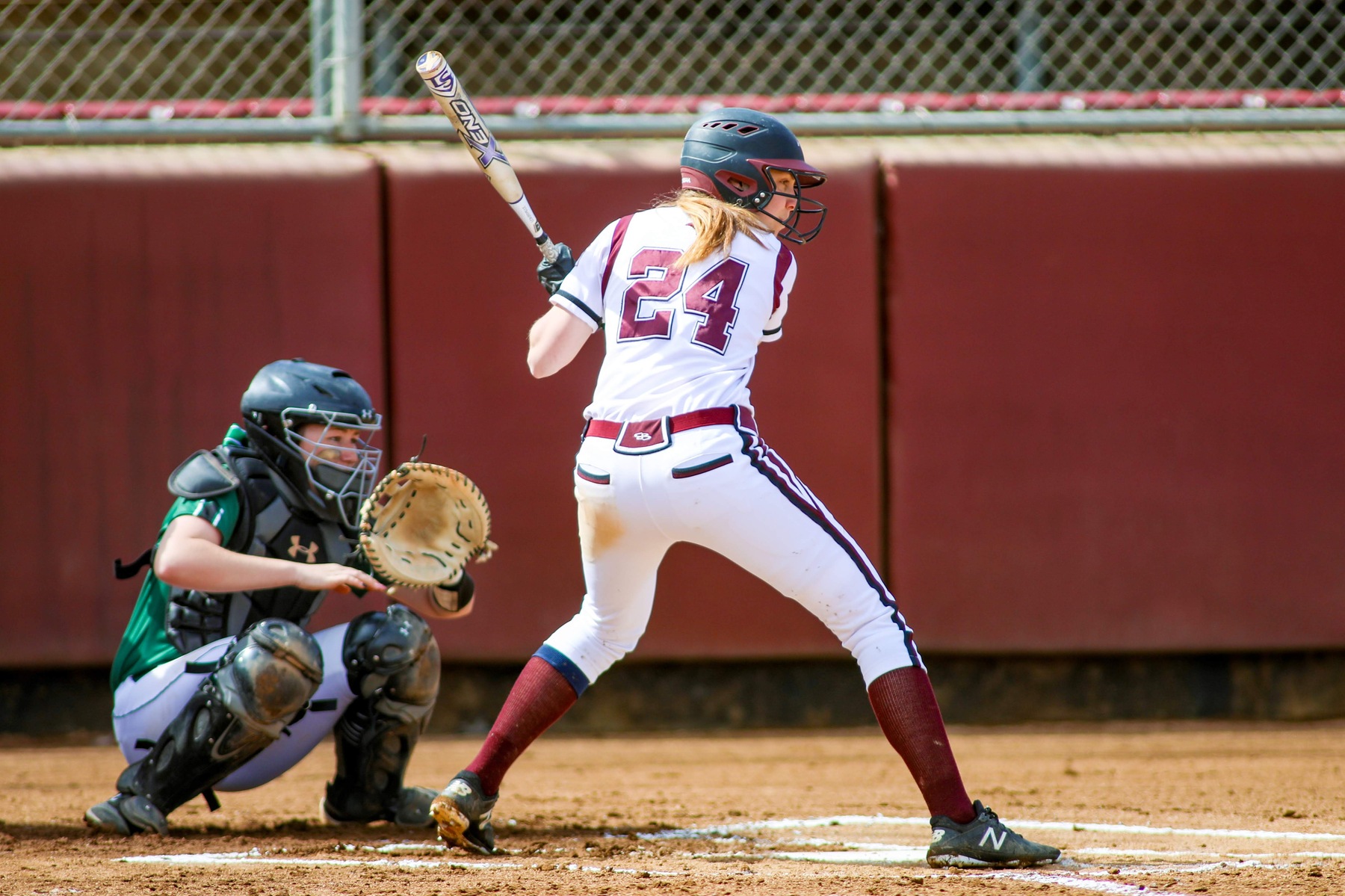 action photo of RC softball player at the plate.