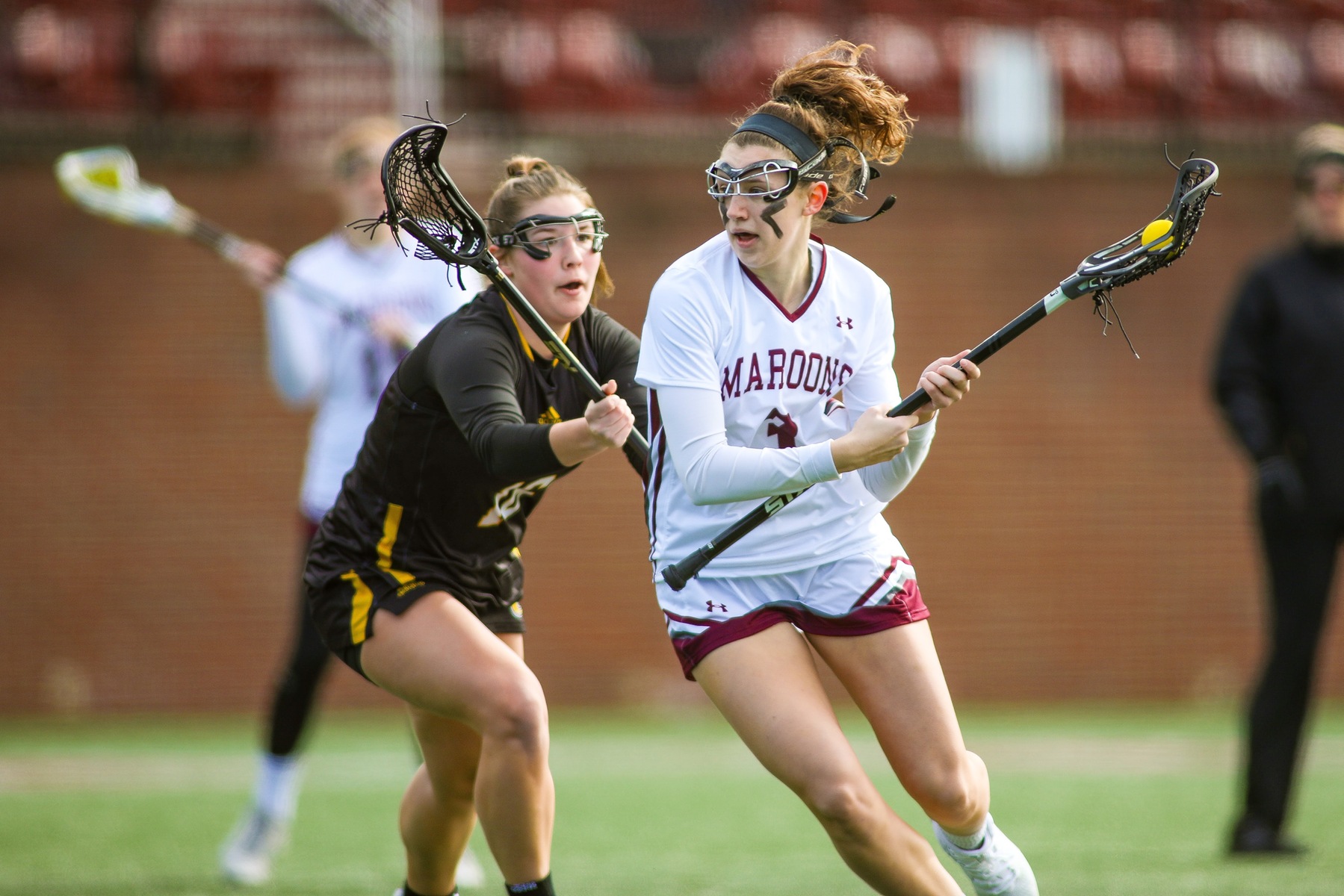 action photo of RC lacrosse player Lilly Blair driving past a defender