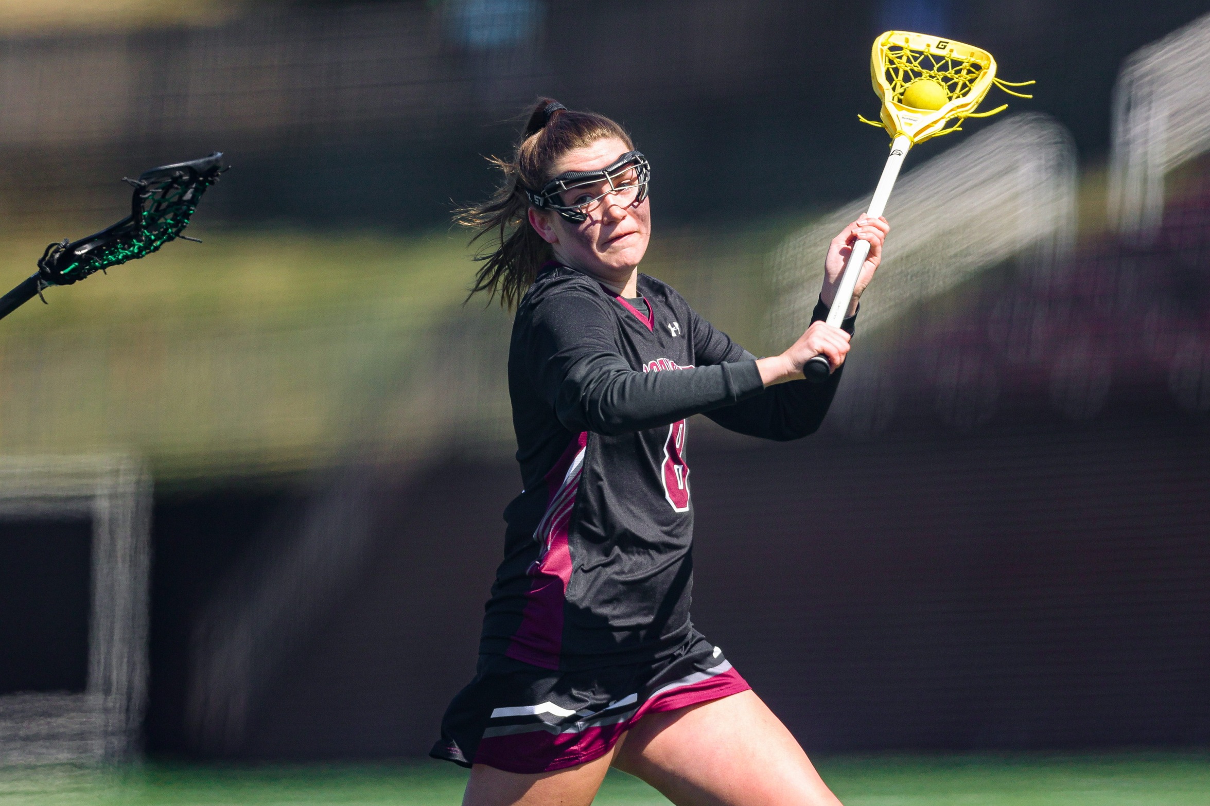 action photo of RC women's lax player Tiernan Connor