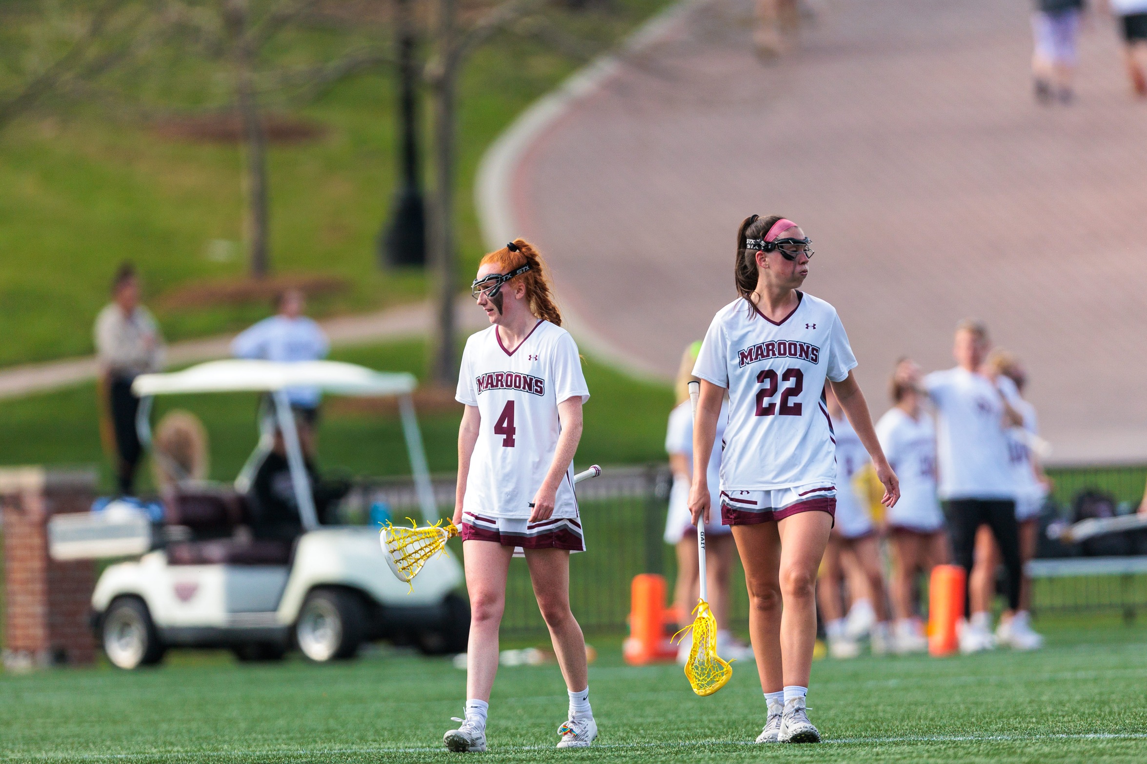 action photo of Molly Kasemeyer (4) and Riley Chase (22) in women's lacrosse game