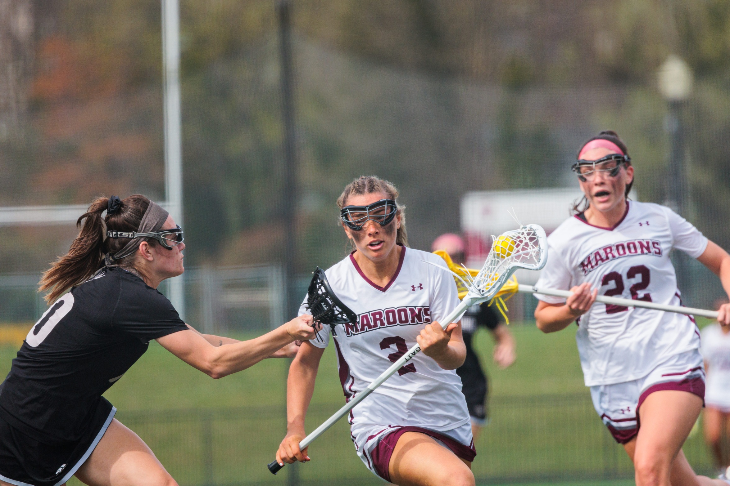 action photo of WLAX Sydney Harrison (2) with the ball and Riley Chase (22) following