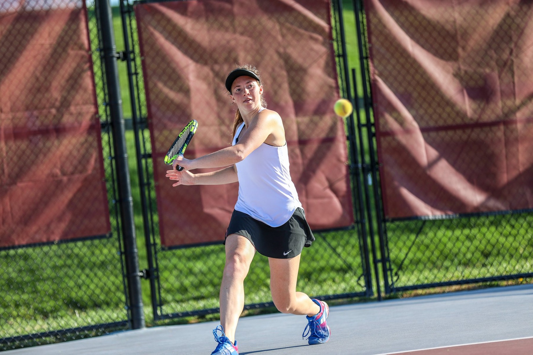 action photo of a RC women's tennis player hitting a backhand