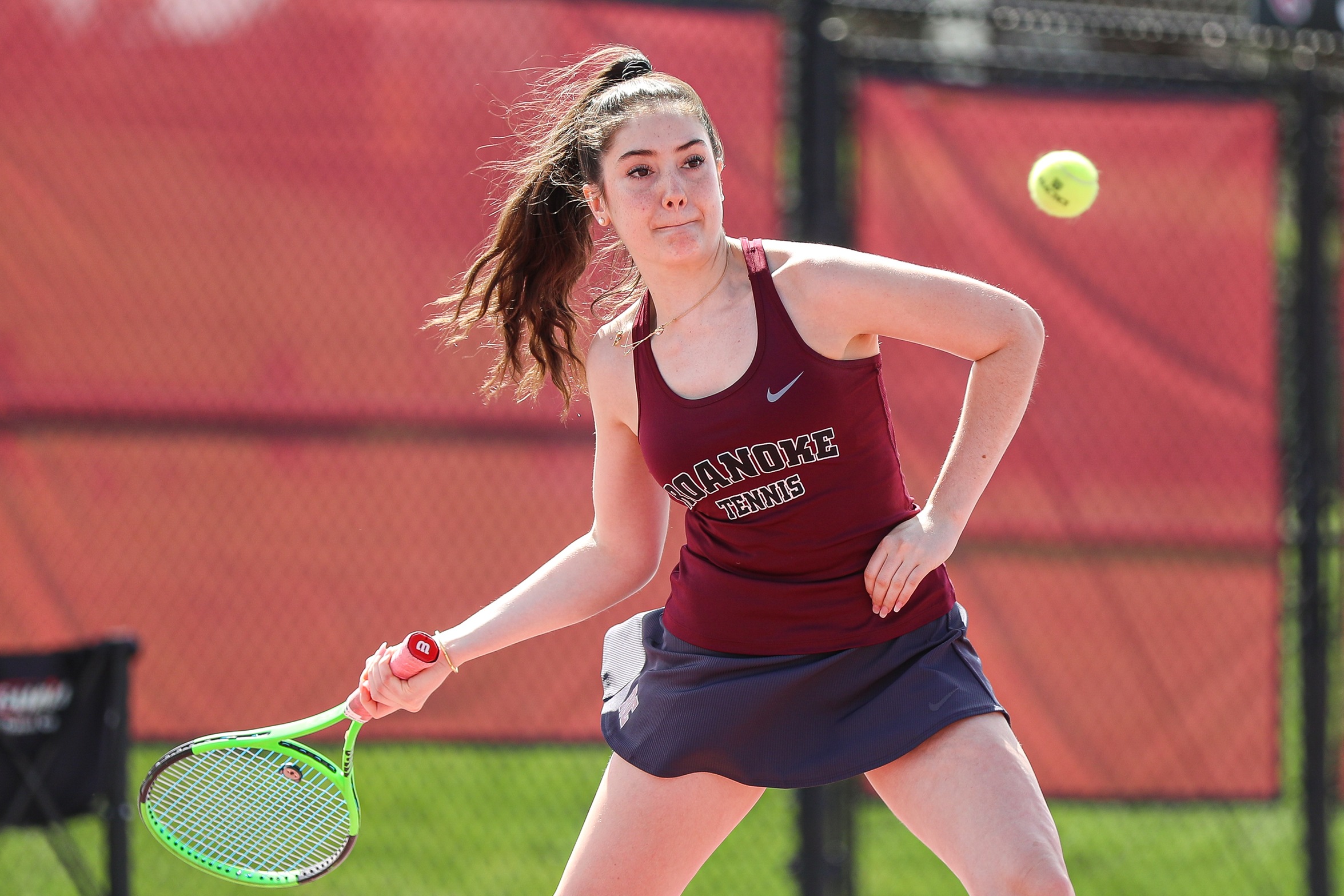 action photo of RC women's tennis player hitting a forehand