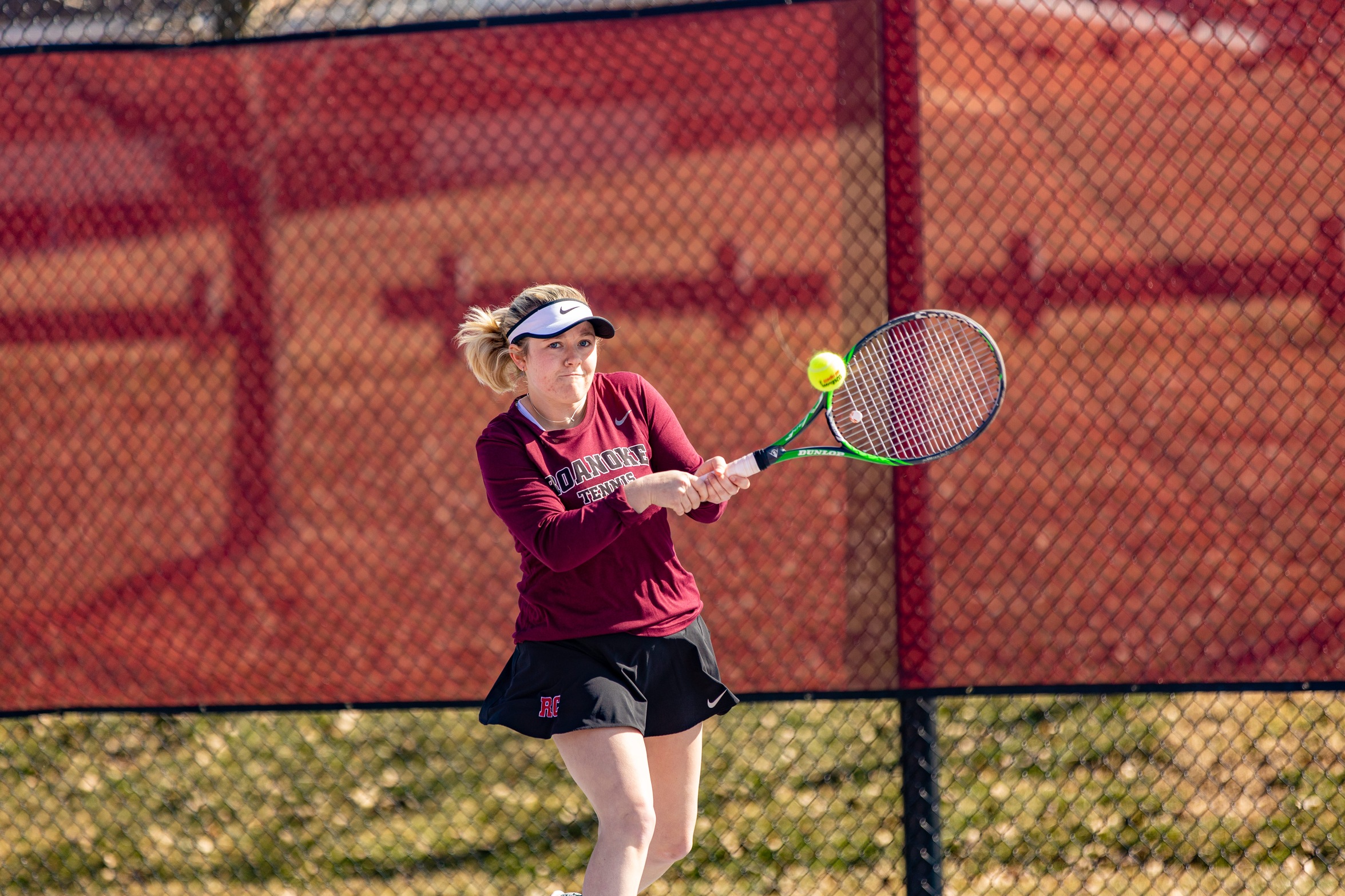 action photo of RC women's tennis player hitting a backhand