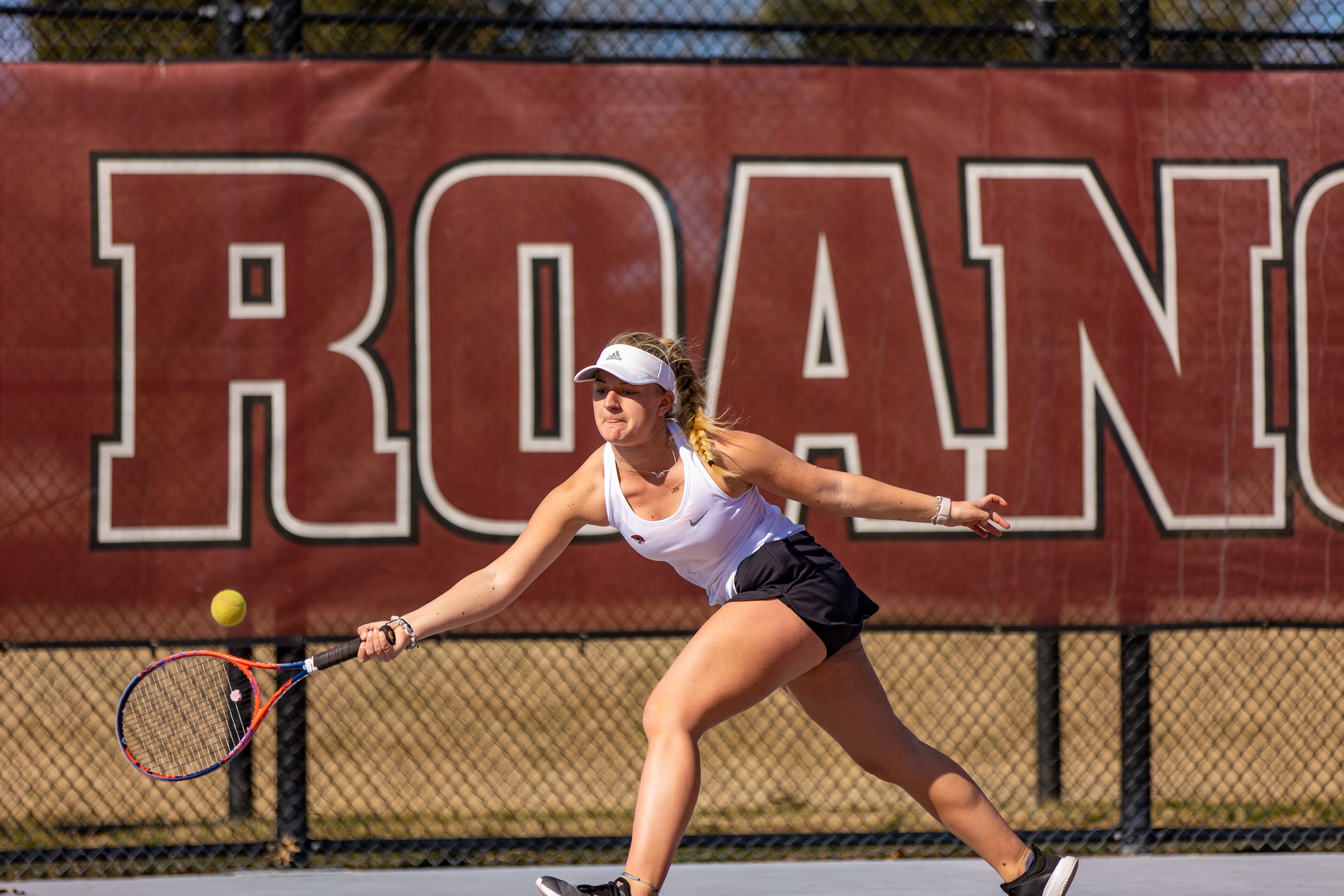 action photo of RC tennis player hitting a running forehand