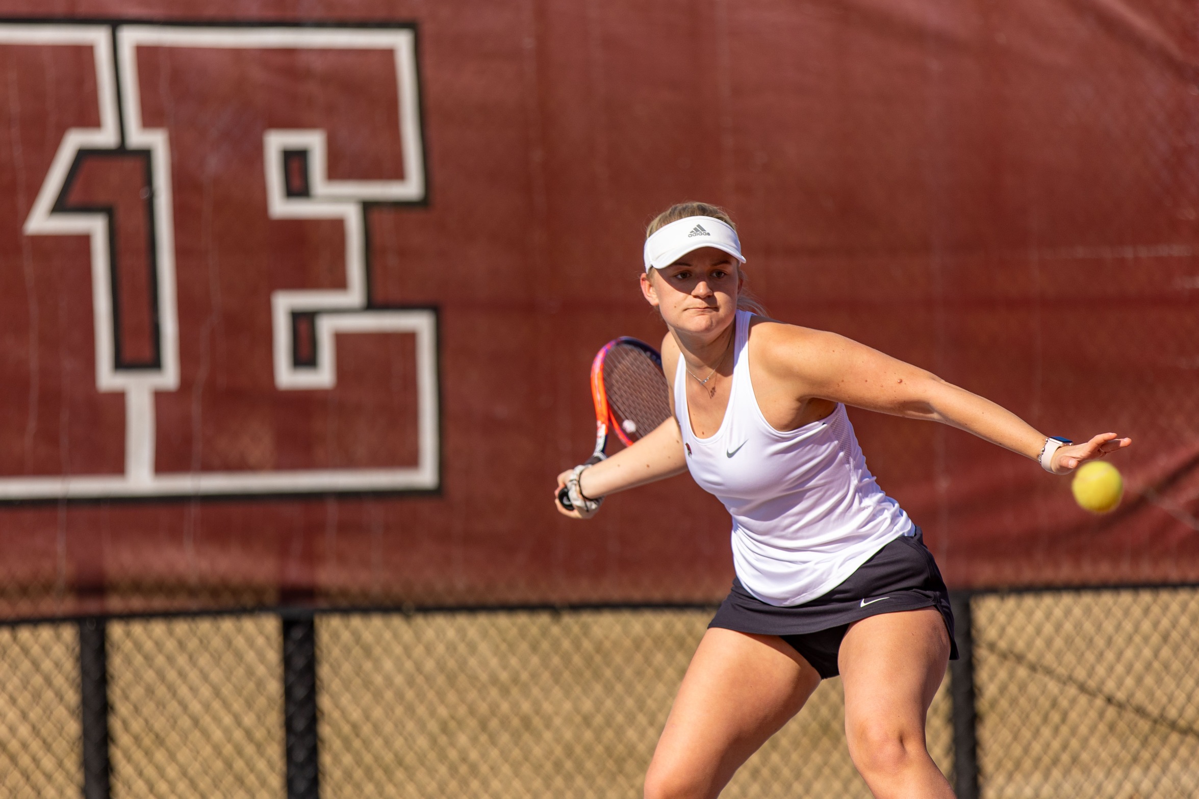 action photo of RC women's tennis player hitting a forehand