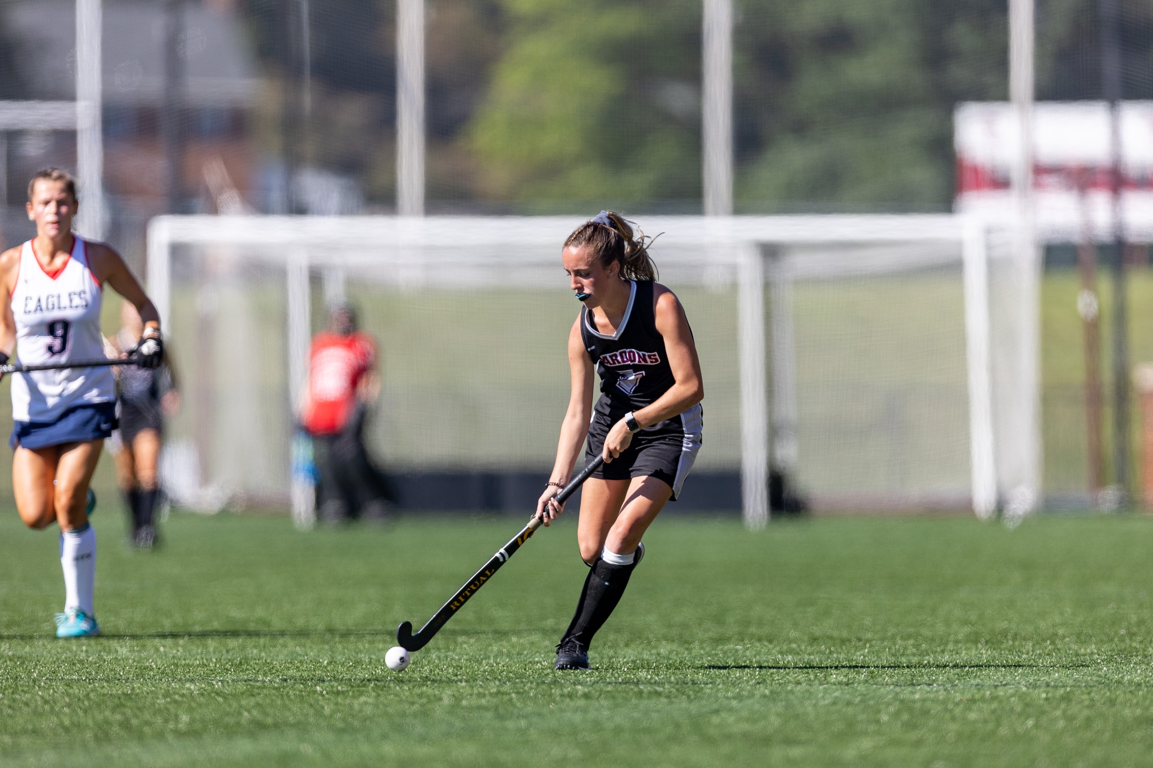 action photo of RC field hockey player Martha Hurley with the ball