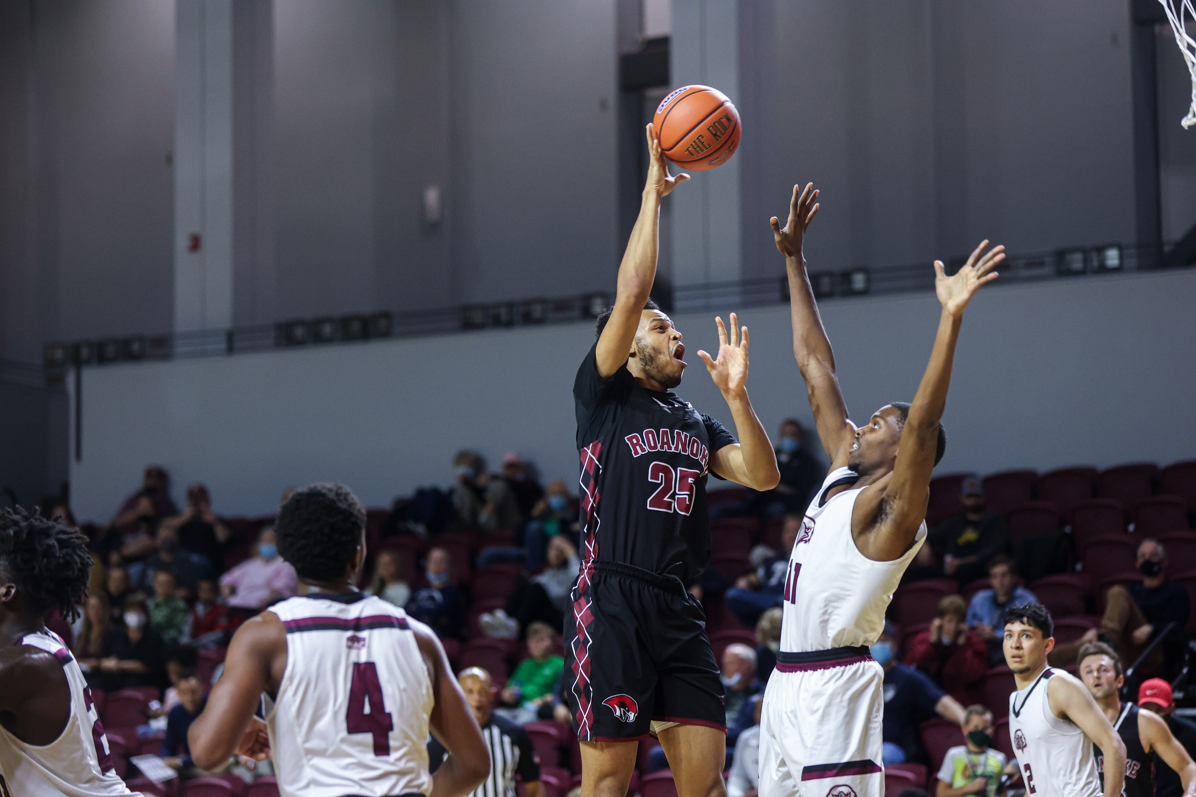 action photo of RC men's basketball player Ethan Rohan with a hook at the hoop