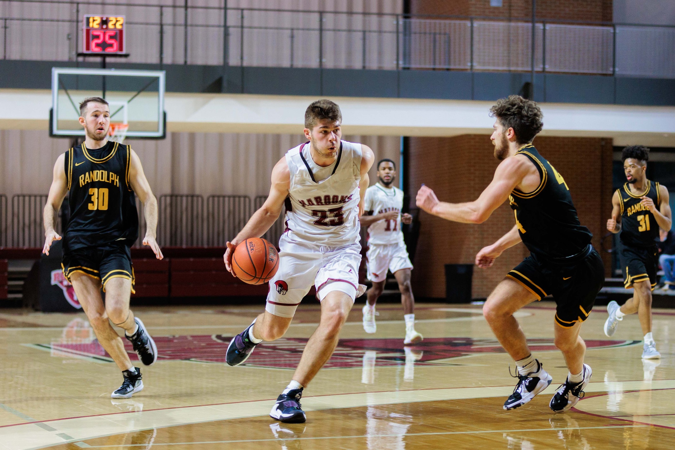 action photo of RC MBB Kasey Draper driving to the basket