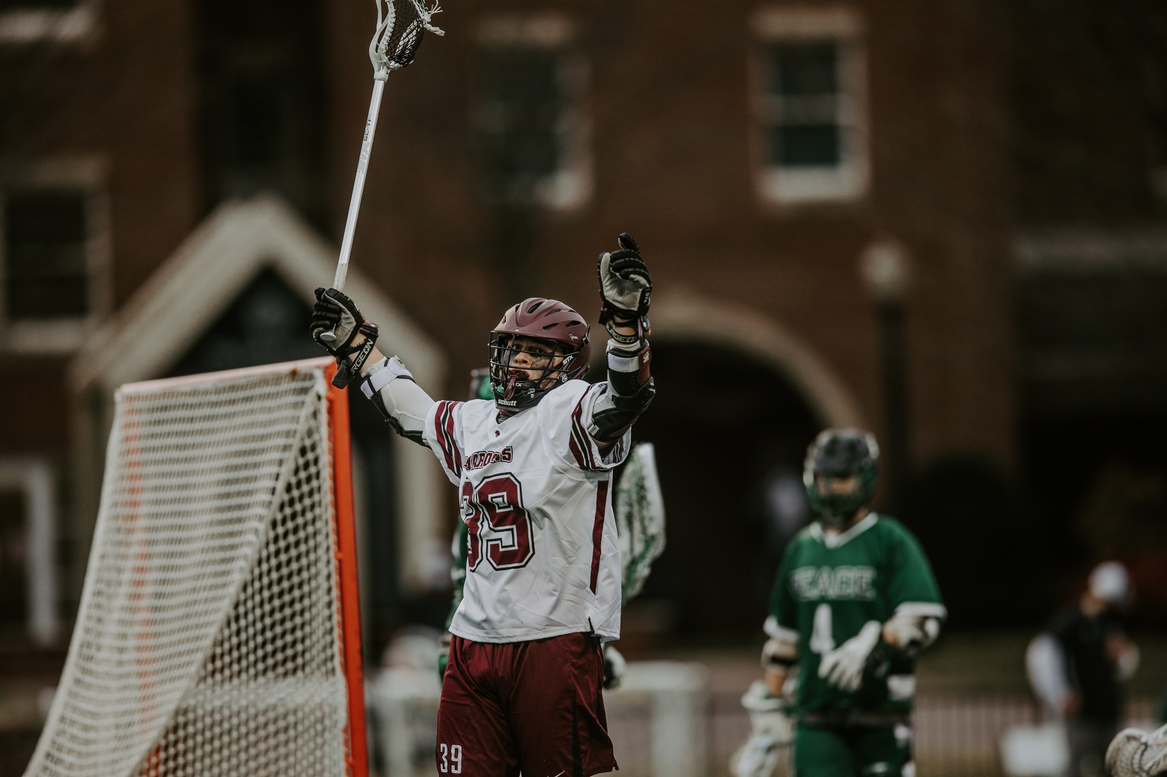 action photo of RC lacrosse player Wyatt Whitlow celebrating a goal