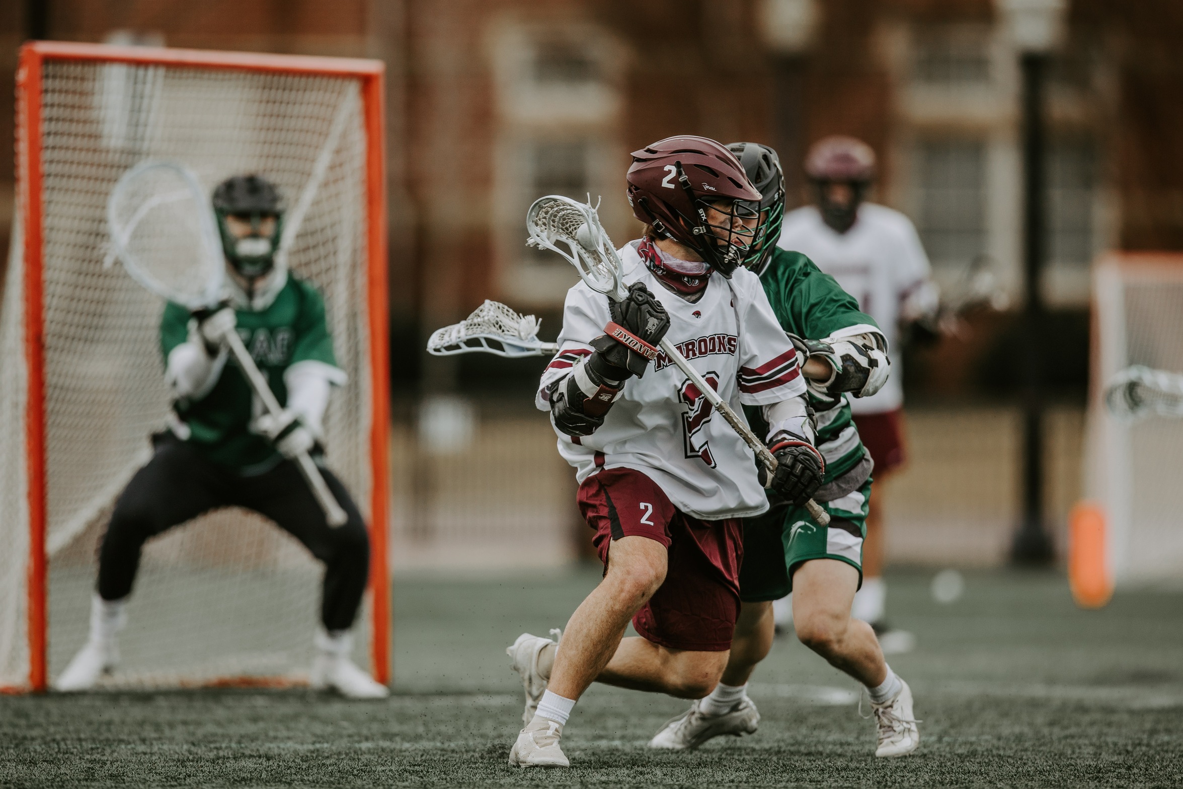action photo of RC lacrosse player Luca Docking against a defender
