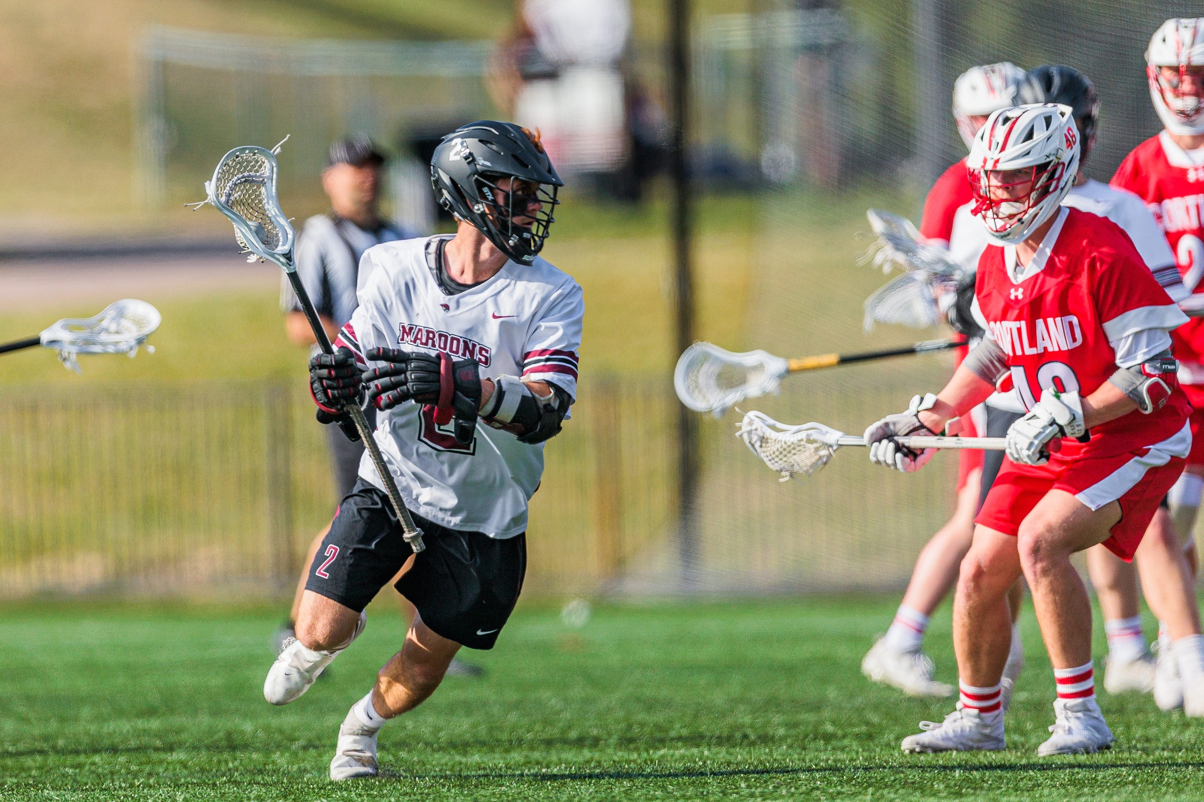 action photo of RC men's lacrosse player Luca Docking with the ball getting ready to shot against a defender