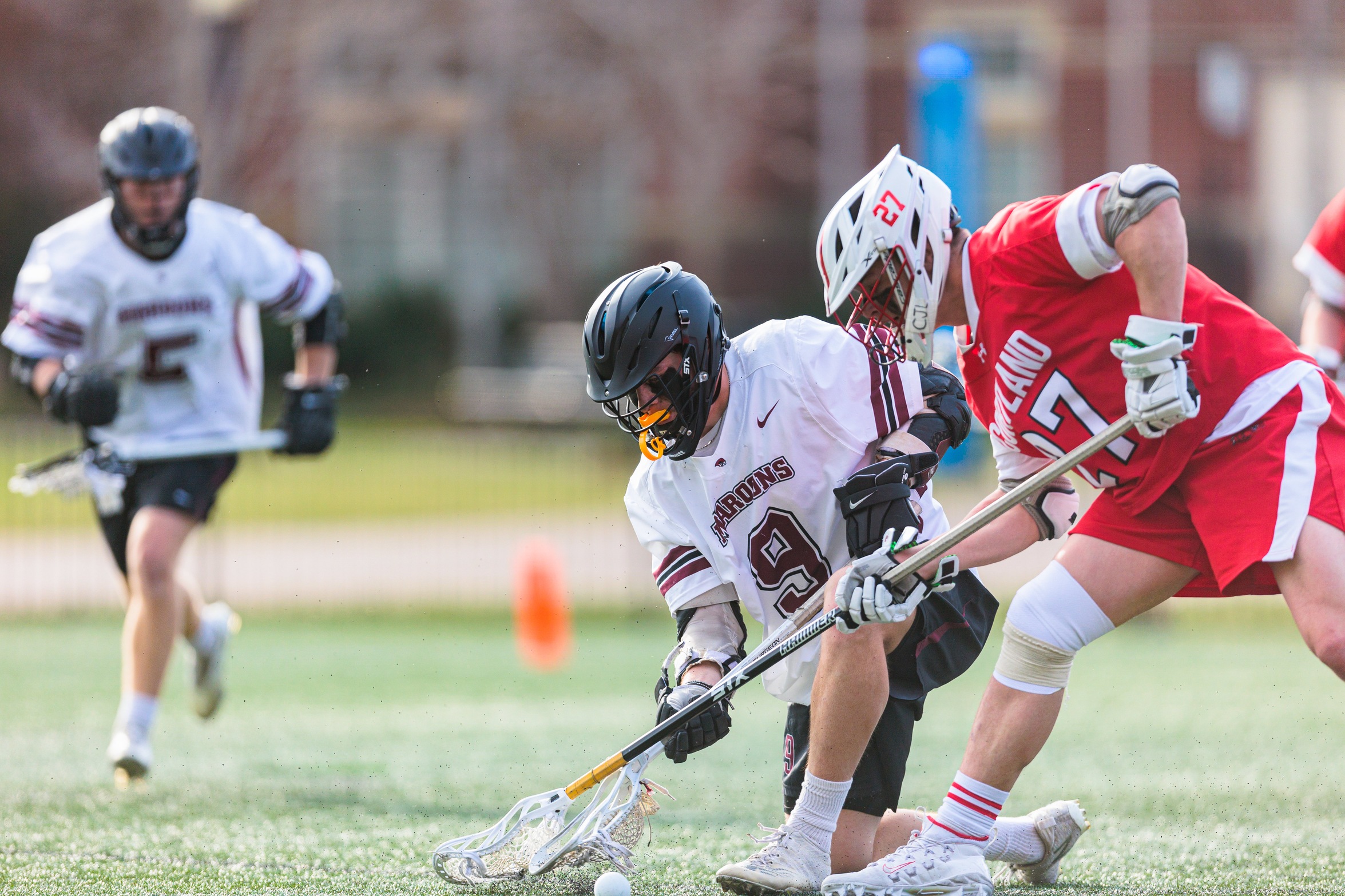 action photo of Wyatt Whitlow battling for a loose ball in MLAX