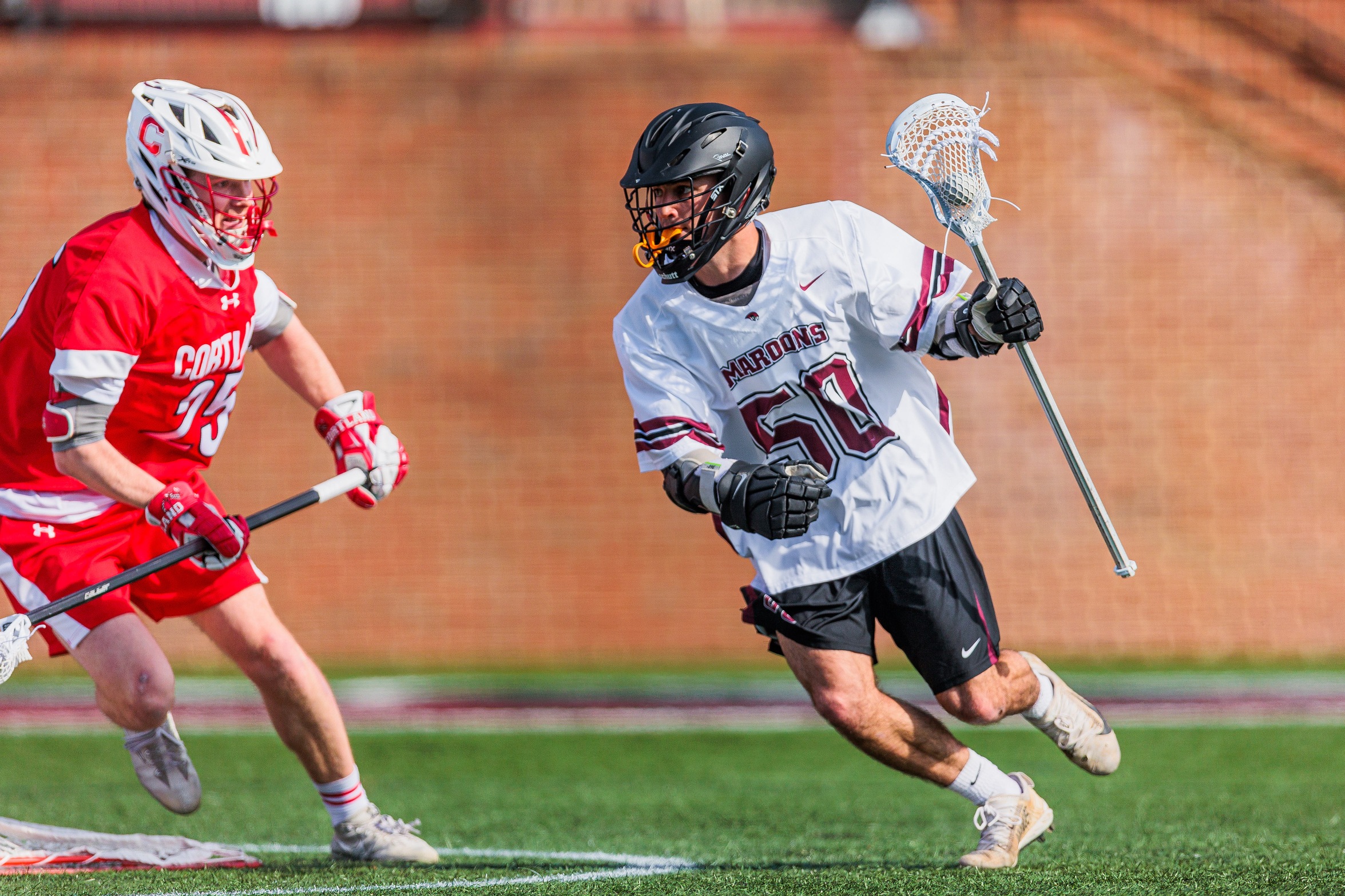 action photo of RC mlax Ethan Caldwell with the ball against a defender