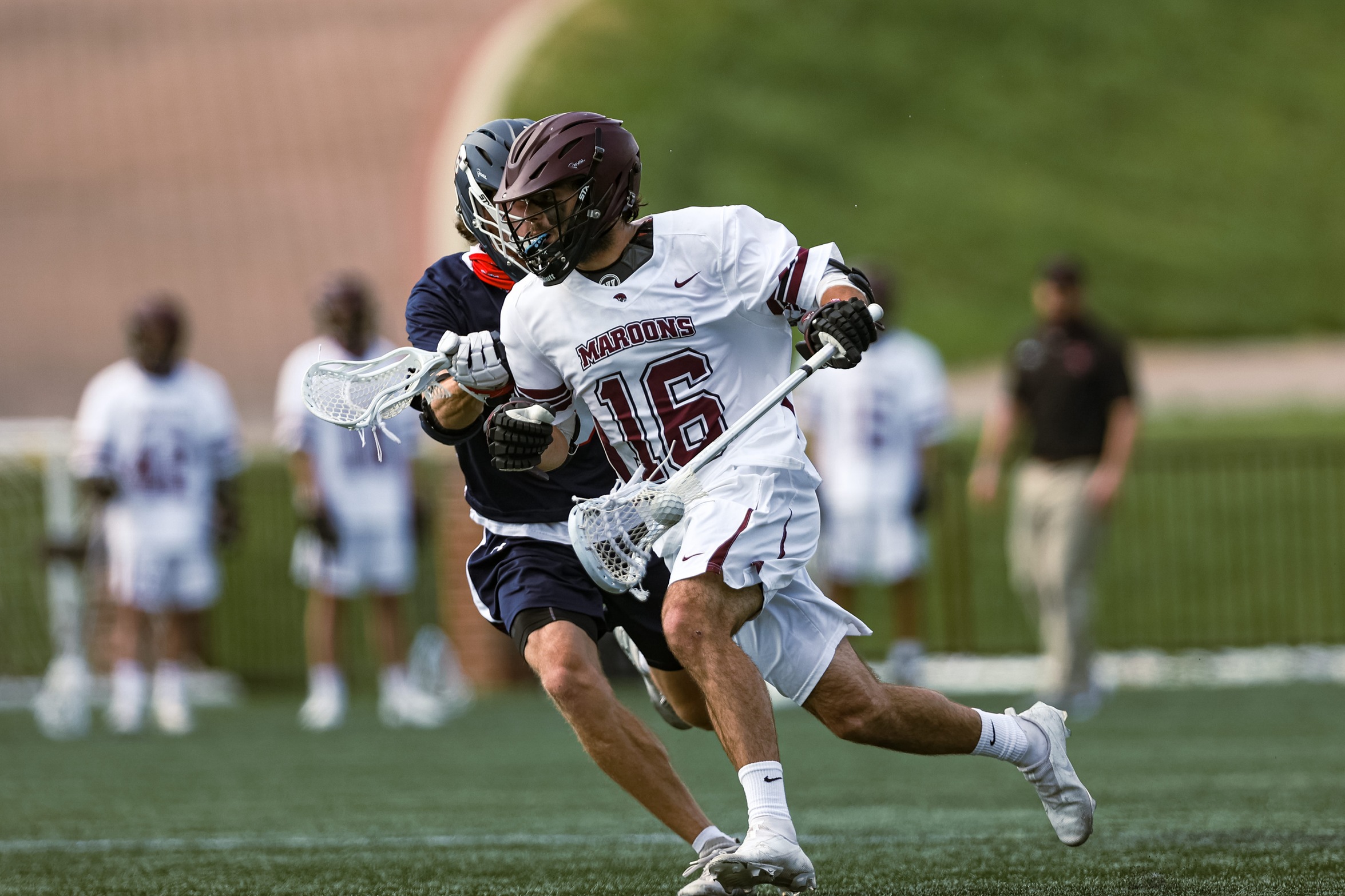 action photo of RC MLAX George Gilbert with the ball an da defender on his back