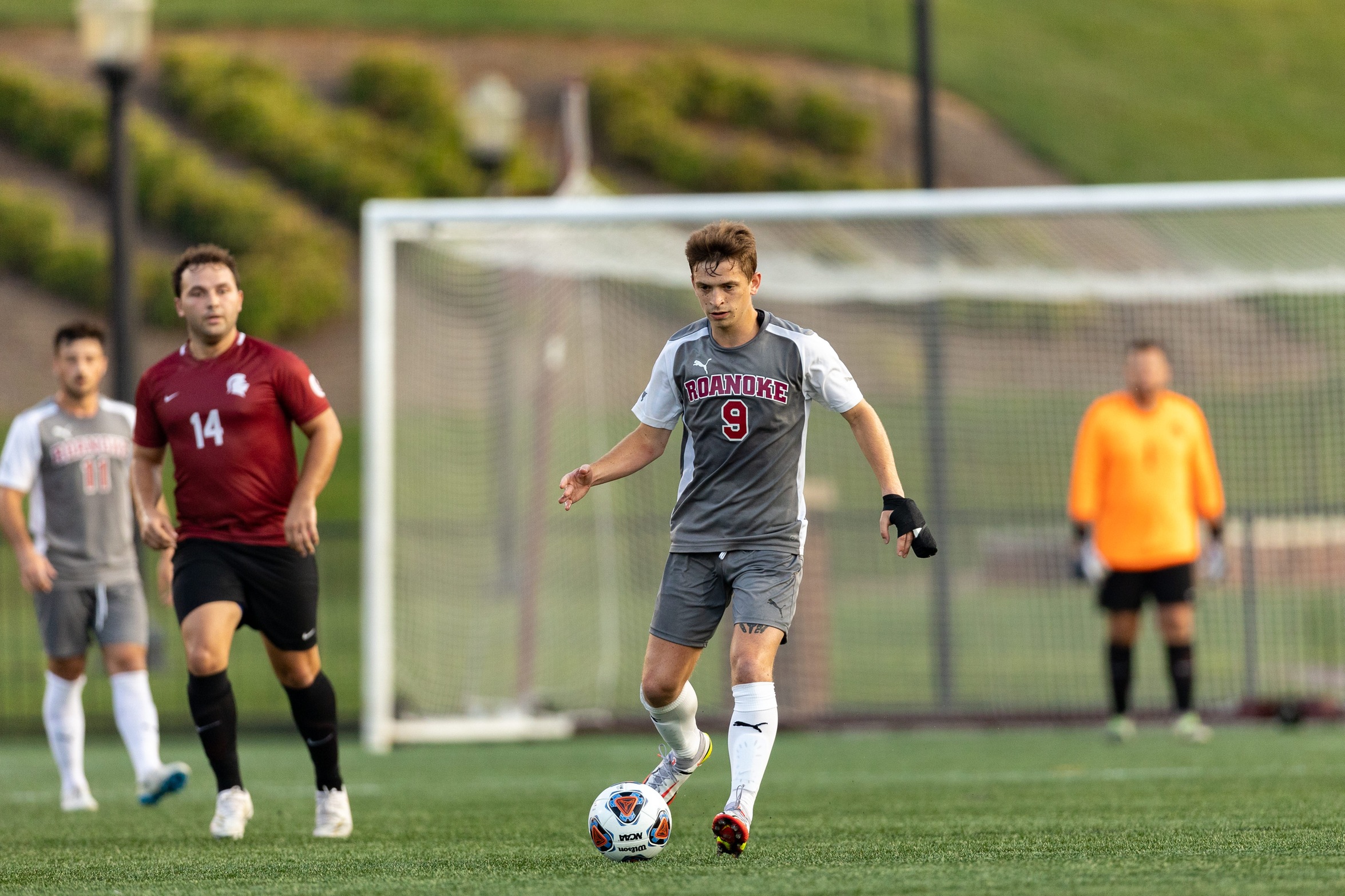 action photo of RC men's soccer player Isaac Wolf in open ground