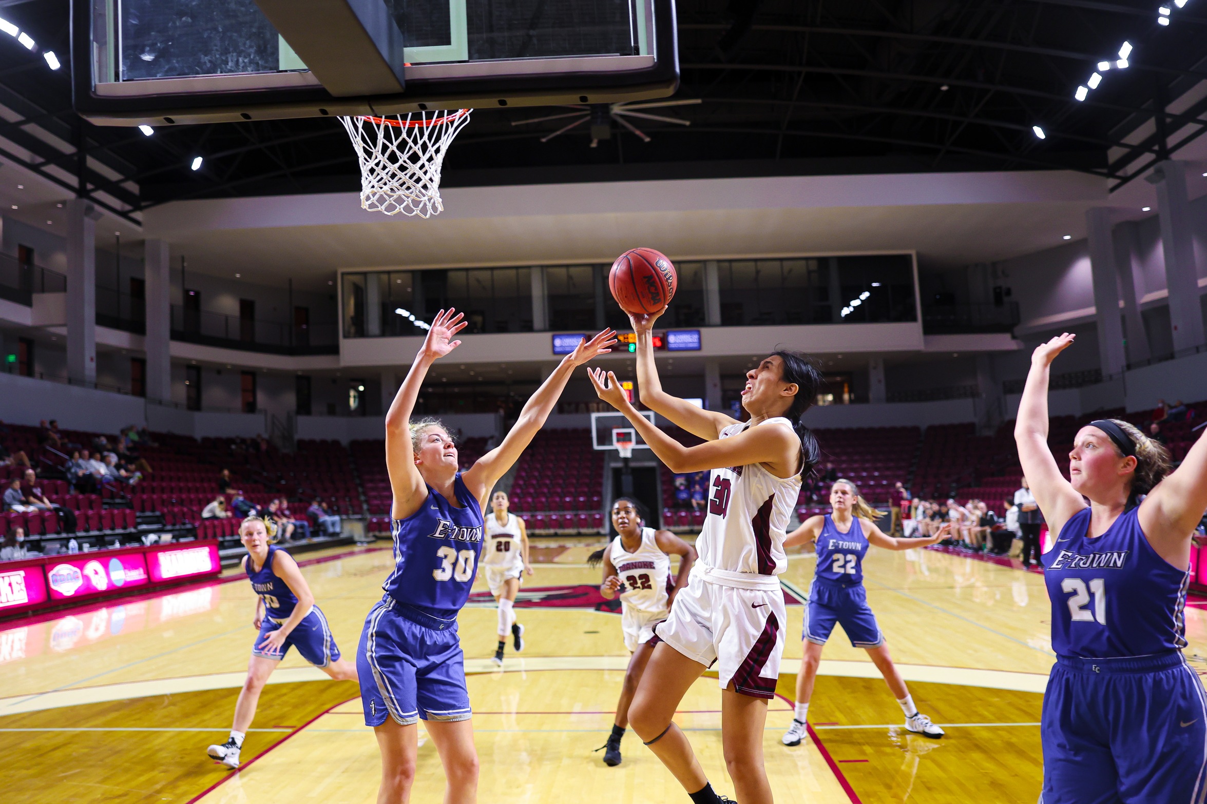 action photo of RC WBB Renee Alquiza going in for the layup