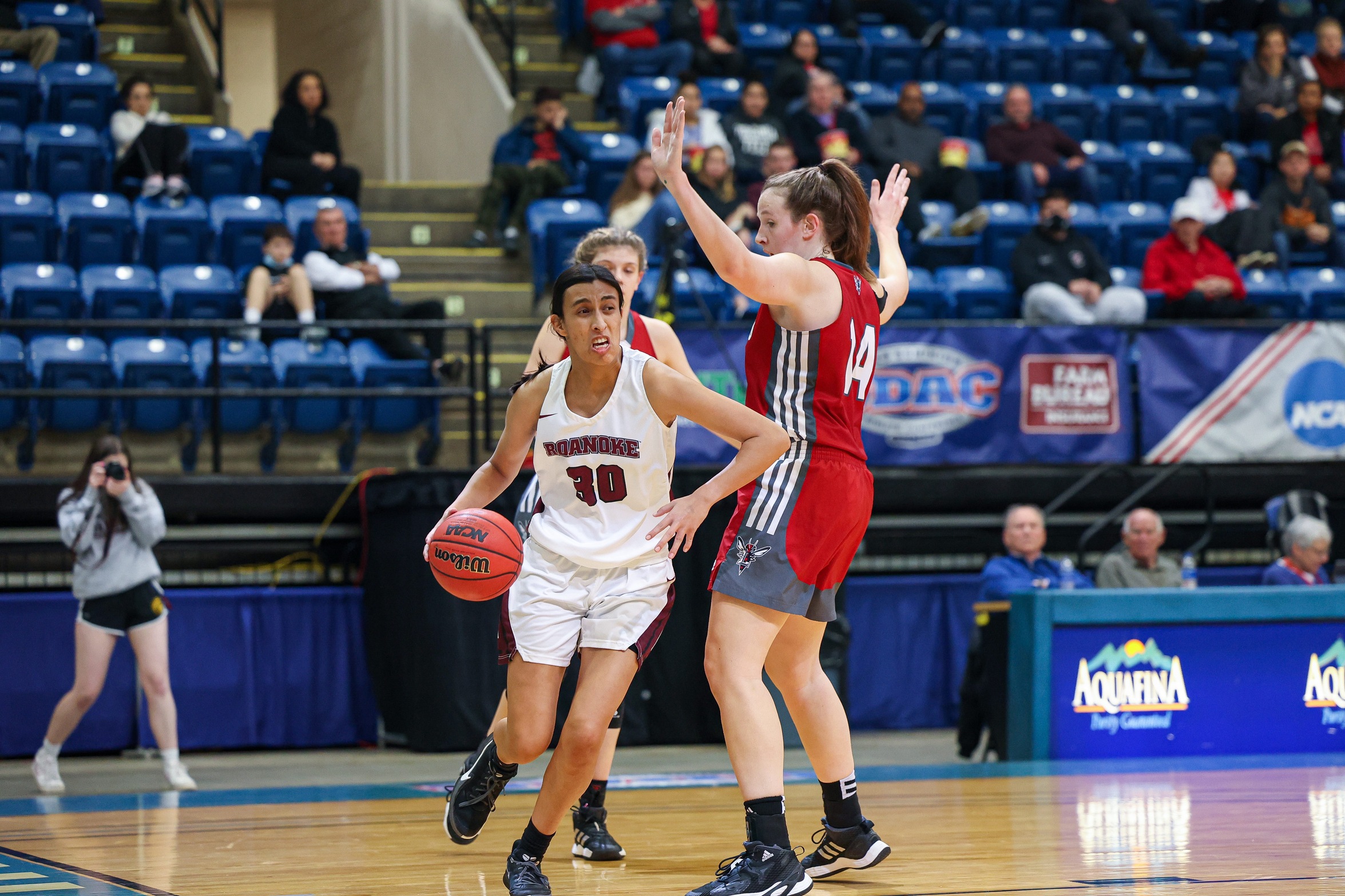 action photo of RC women's basketball player Renee Alquiza driving past a defender