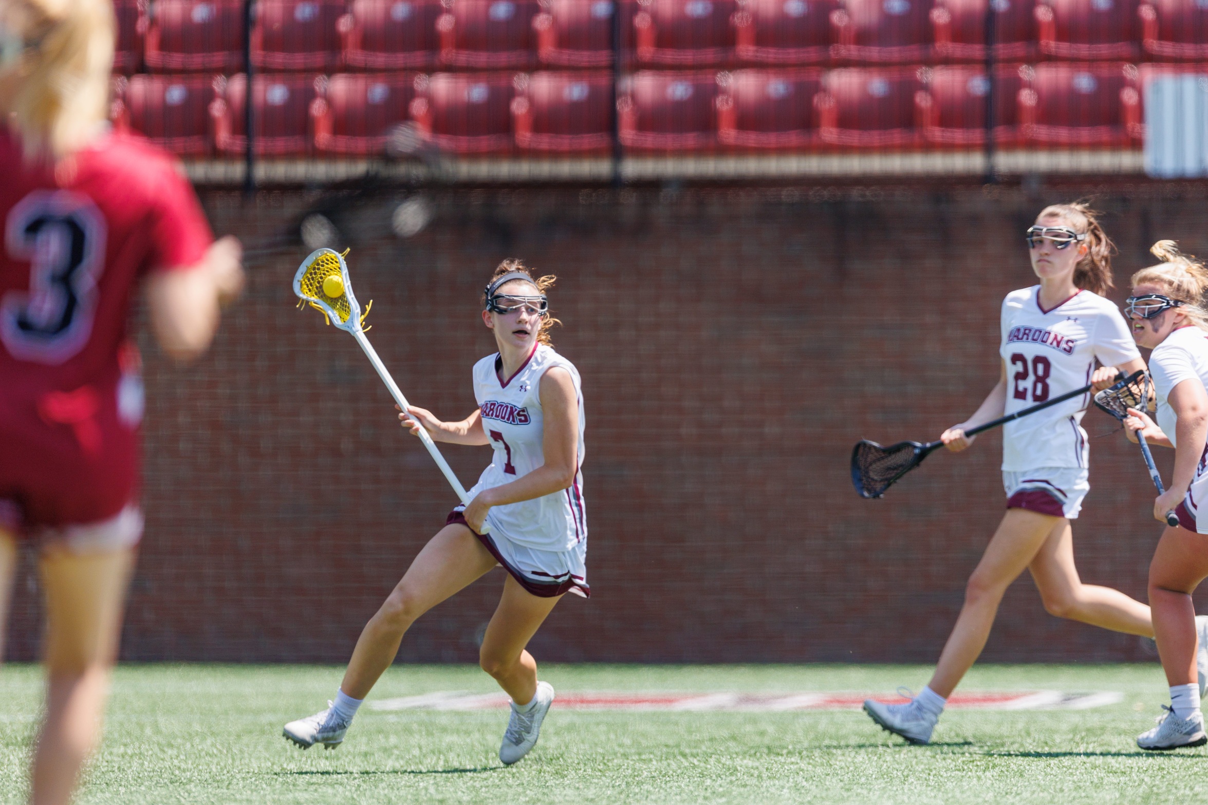 action photo of RC WLAX Lilly Blair with the ball in her stick