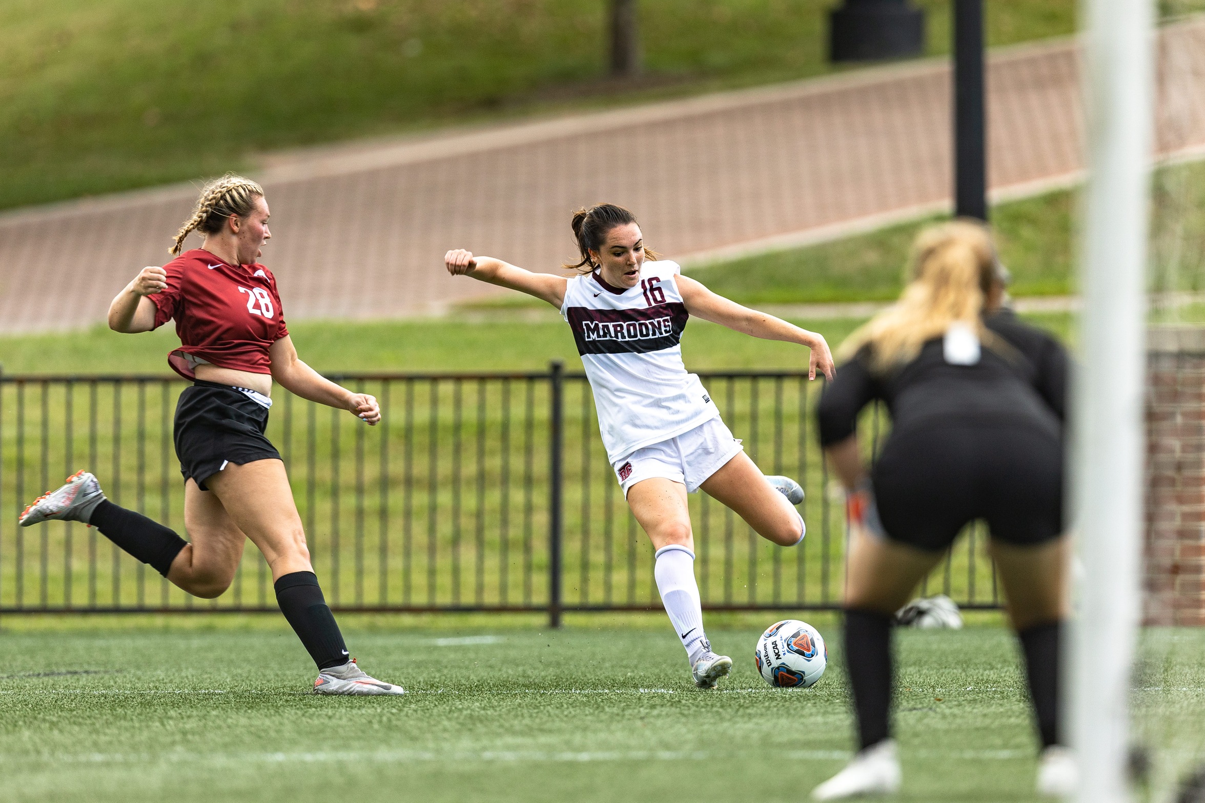 action photo of RC women's soccer player MC Petrucelli with a shot