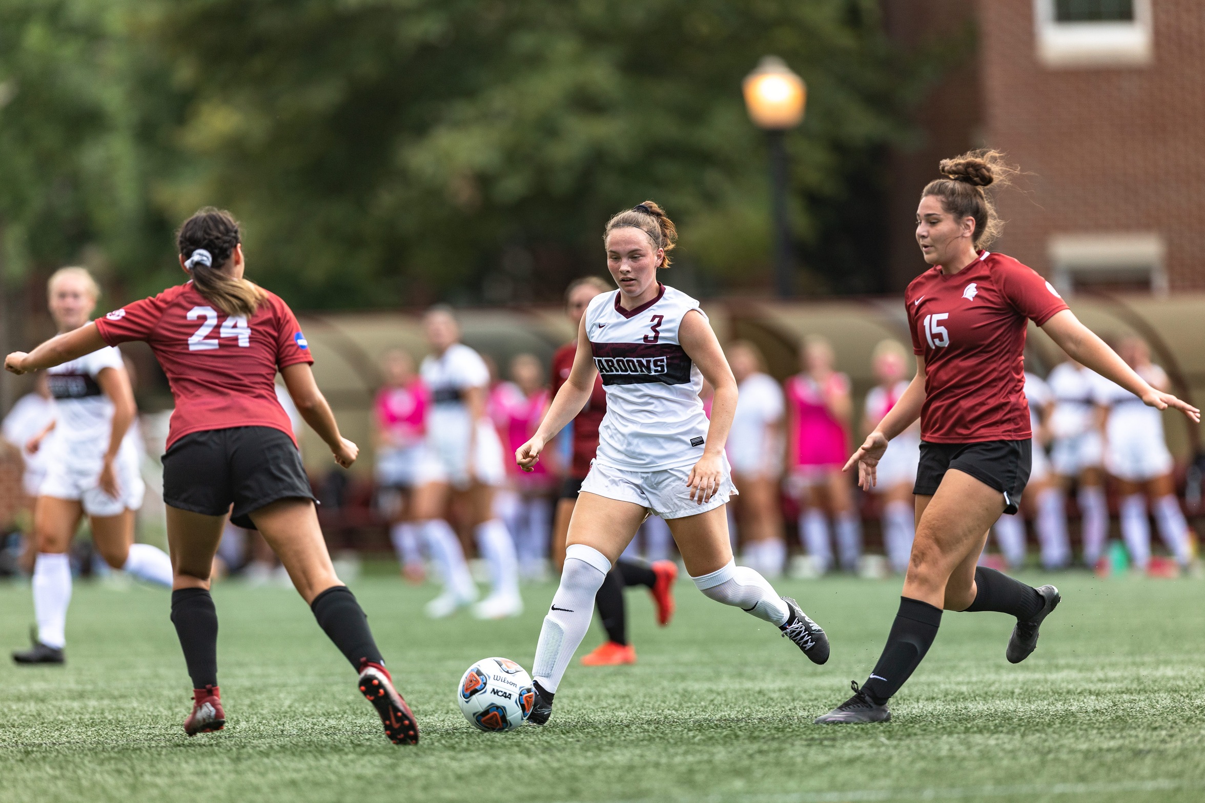 action photo of RC women's soccer player Lilly Pawliczak between defenders