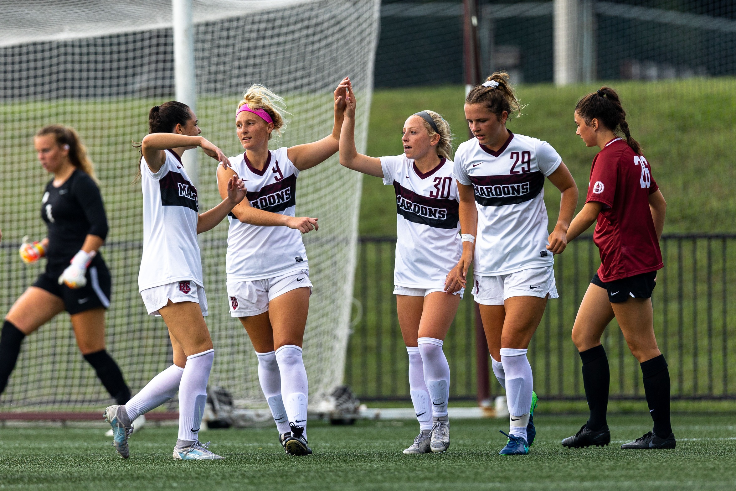 action photo of RC women's soccer celebration after a goal