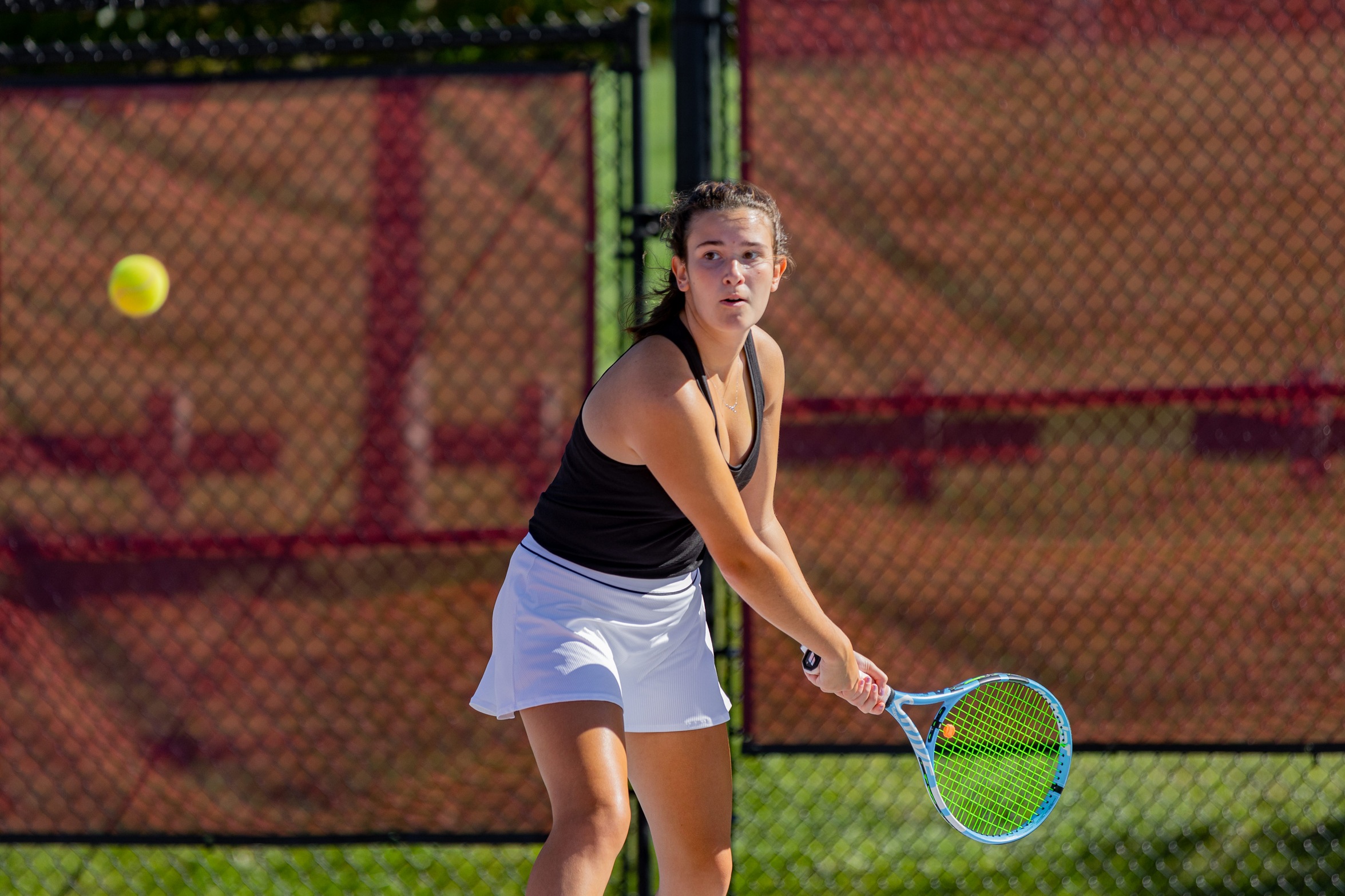 action photo of Rc women's tennis player hitting a backhand
