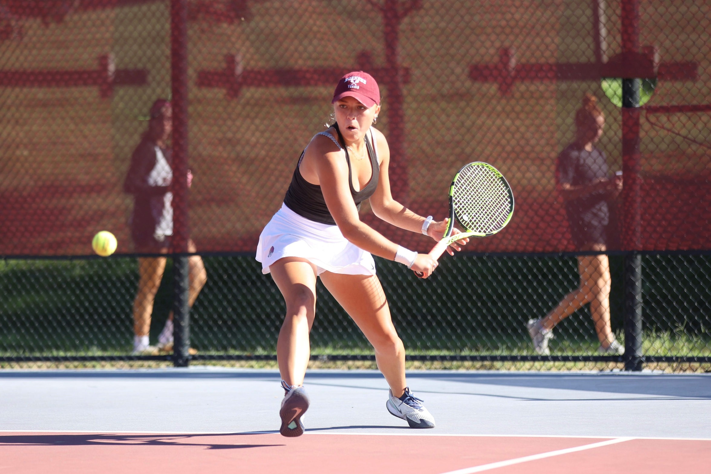 action photo of RC women's tennis player hitting a backhand