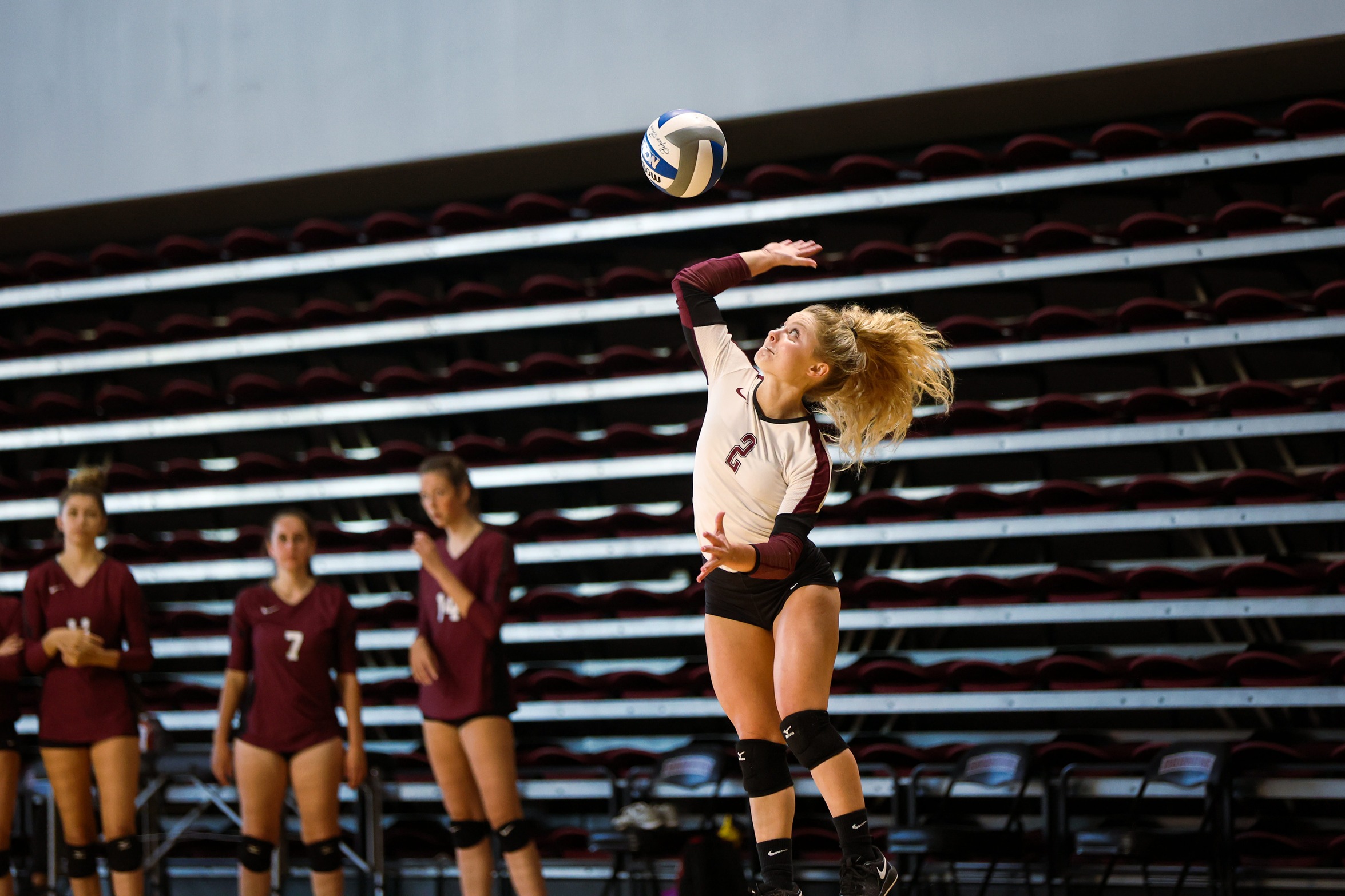 action photo of RC volleyball player Kennedy Clemmer serving