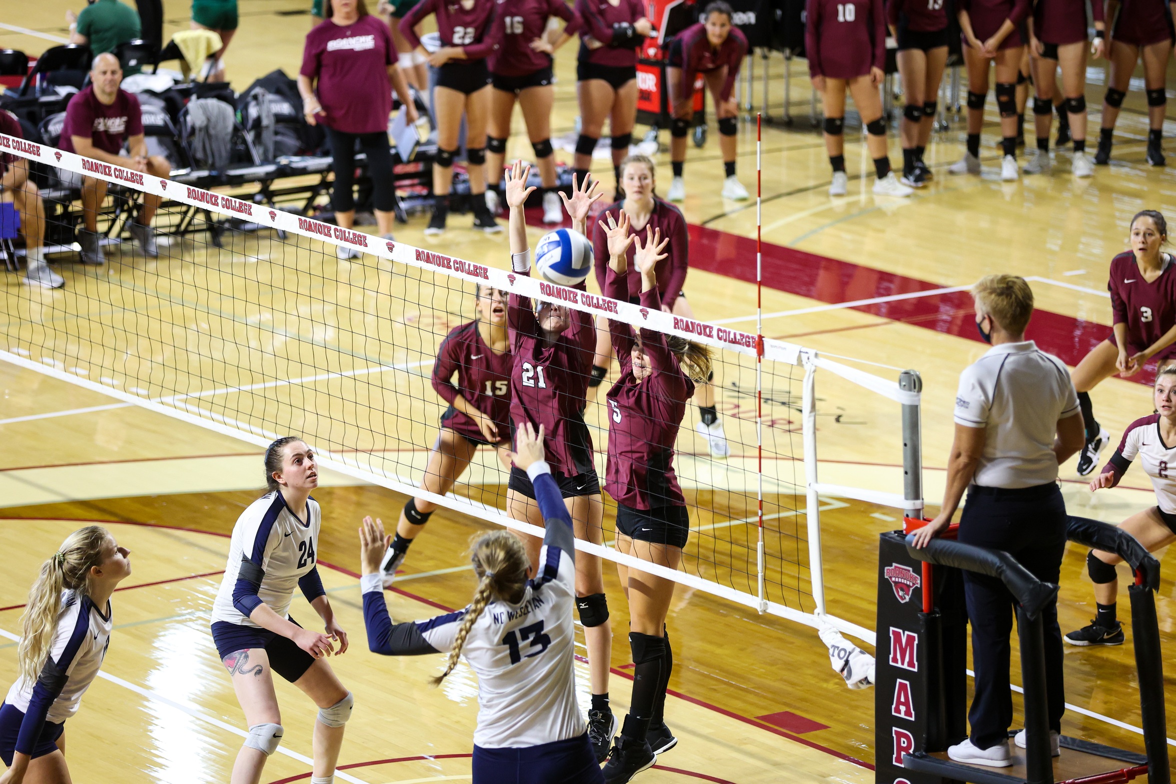 action photo of two RC volleyball players blocking at the net