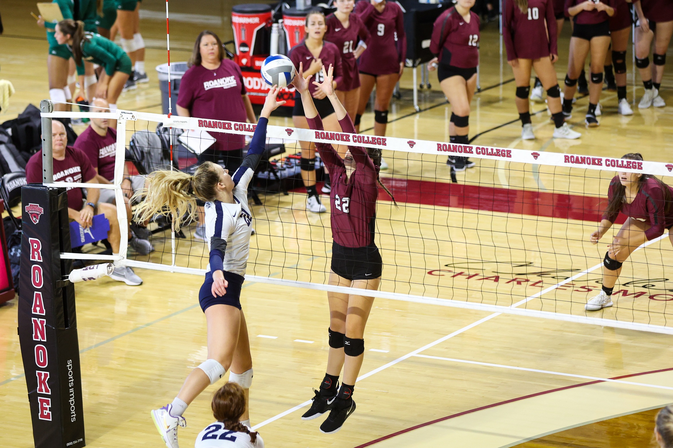action photo of RC volleyball player Rylee Mayer blocking at the net